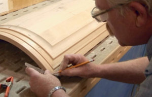 man working on wooden cabinet