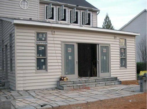 a small house with two windows and a porch