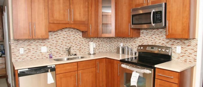 a kitchen with wooden cabinets and stainless steel appliances