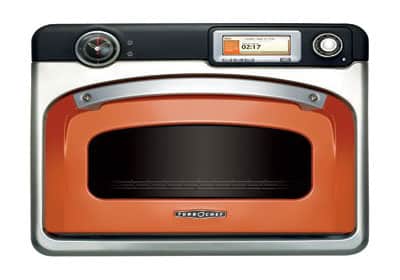 an orange and silver oven on a white background
