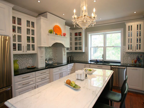 Remodeled kitchen with chandelier over large kitchen island