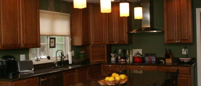 a kitchen filled with lots of wooden cabinets