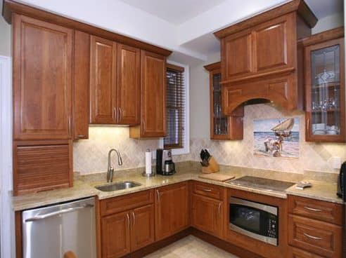 a kitchen with wooden cabinets and stainless steel appliances