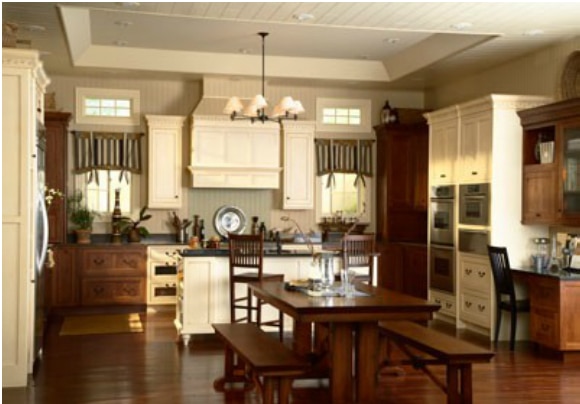 a kitchen with wooden floors and white cabinets