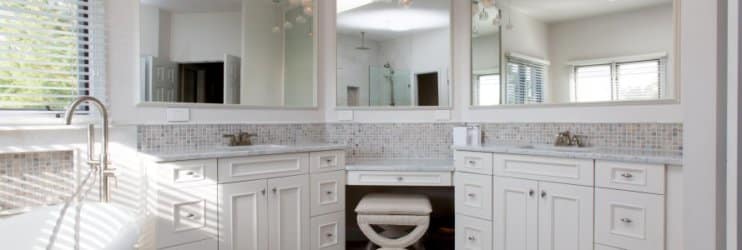 Remodeled bathroom with white cabinetry