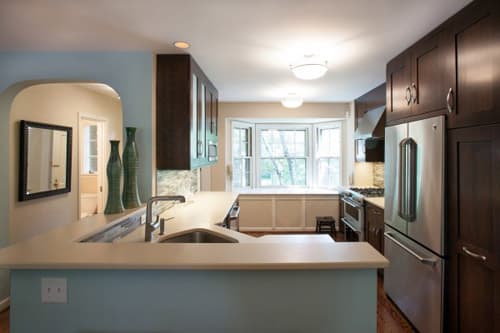 a kitchen with a sink, stove and refrigerator