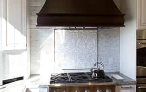 a stove top oven sitting inside of a kitchen