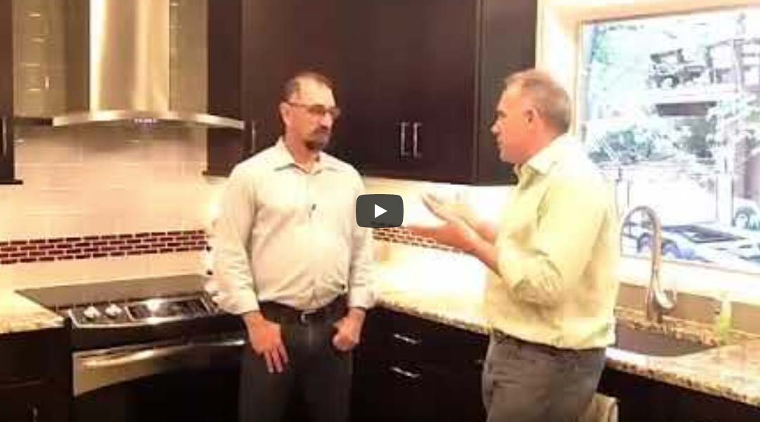 Video thumbnail of two men standing in a newly renovated kitchen talking.