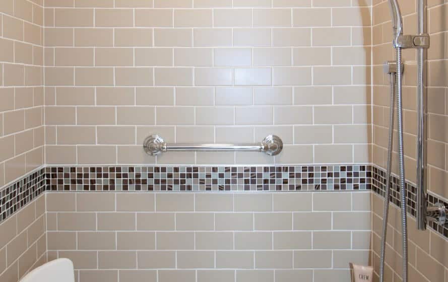 a tiled bathroom with a toilet and shower