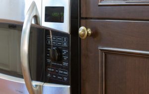 Close-up of microwave and cabinetry
