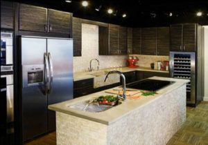 Renovated kitchen with dark gray cabinets and white island.