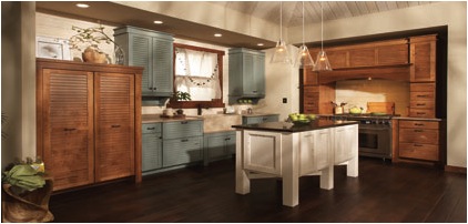 Remodeled kitchen design with wood-grain cabinets, white island, and dark floors.