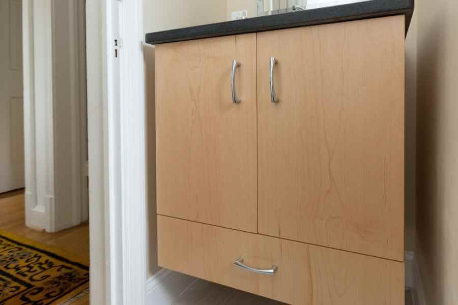 a bathroom with a cabinet and mirror on the wall