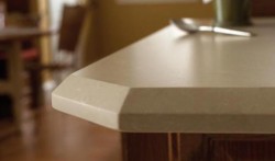 Close-up of a squared-off corner of white quartz countertop.