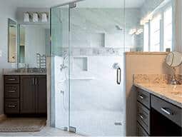 Wide corner shower with a class door and one sink on each side