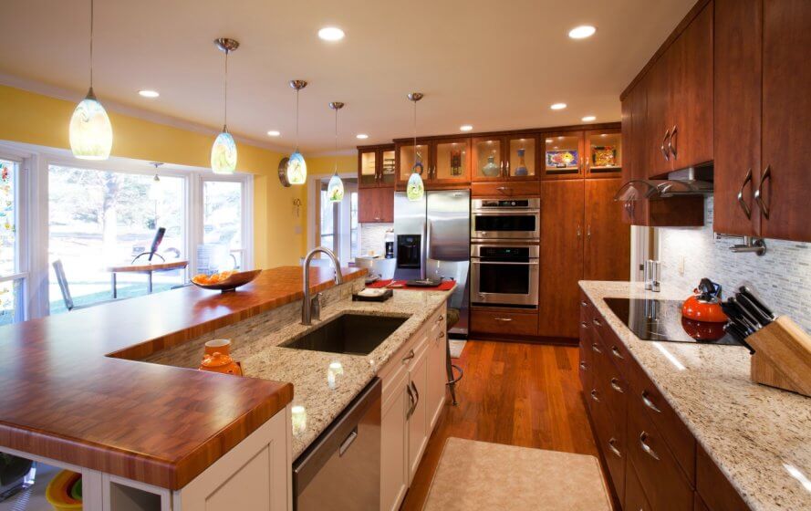 a large kitchen with wooden cabinets and granite counter tops