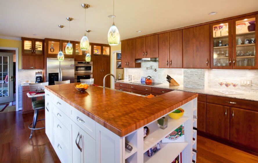 a large kitchen with wooden floors and cabinets