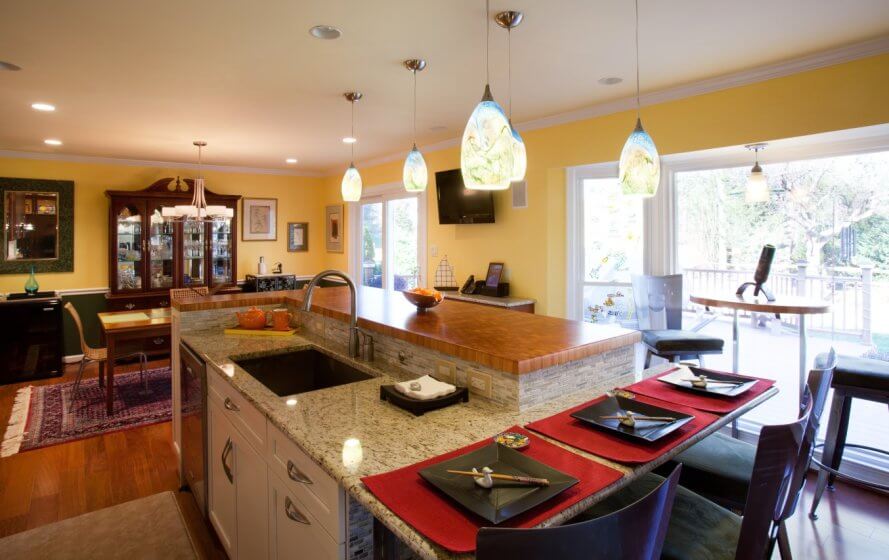 a kitchen with a counter, sink and dining room table