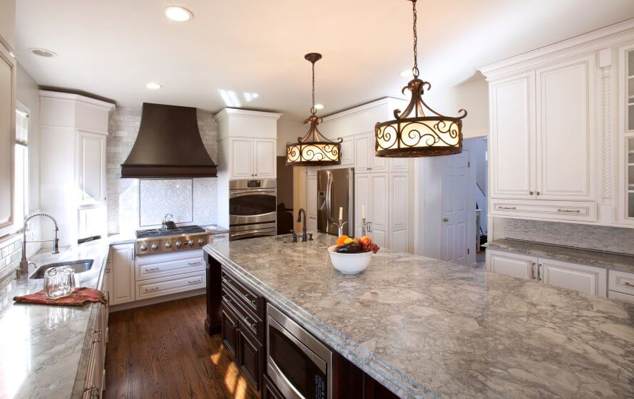 Remodeled kitchen in Bethesda with large kitchen island, recessed lighting, and pendant lighting