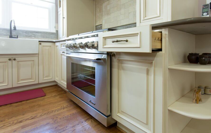 a kitchen with white cabinets and an oven