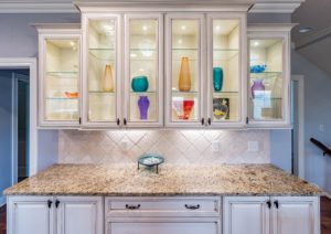 accent lighting in glass-paned cabinets in a kitchen