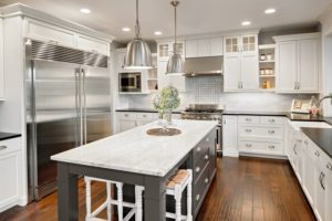Light, bright kitchen remodel with white cabinets and contrasting dark island base.