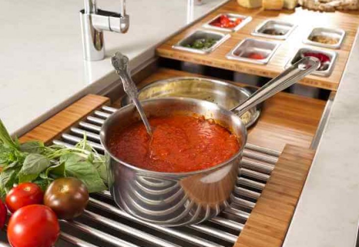 a pot full of tomato sauce next to some vegetables