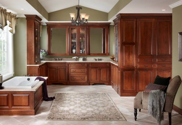 a large bathroom with wooden cabinets and a bathtub