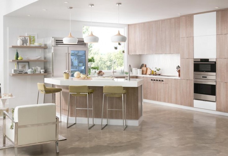 a modern kitchen with an island and bar stools