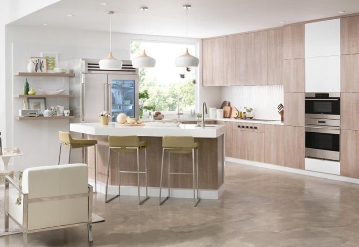 a modern kitchen with an island and bar stools