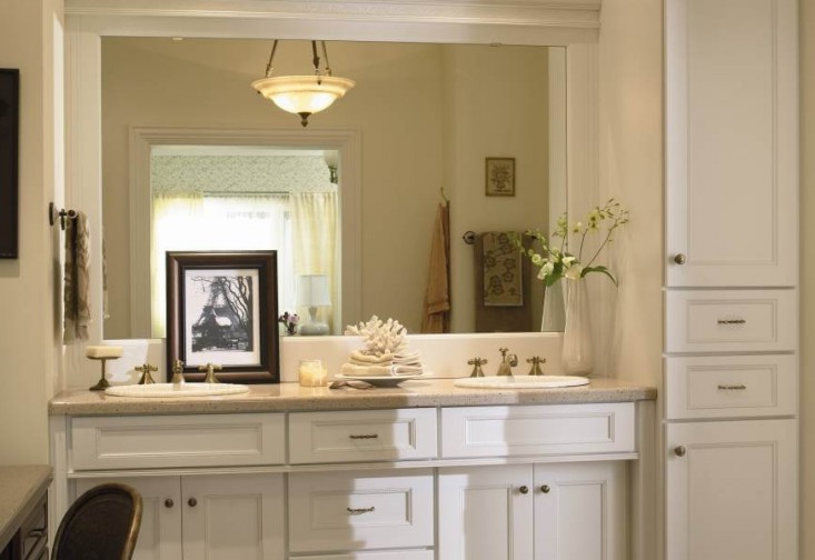 a bathroom with a sink, mirror and cabinets