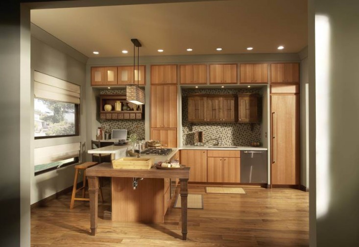 a large kitchen with wooden cabinets and an island