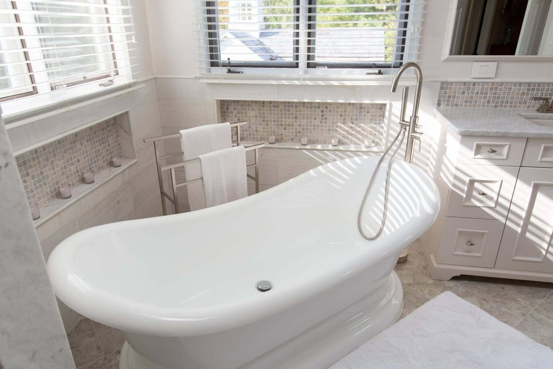 a large white bath tub sitting next to a window