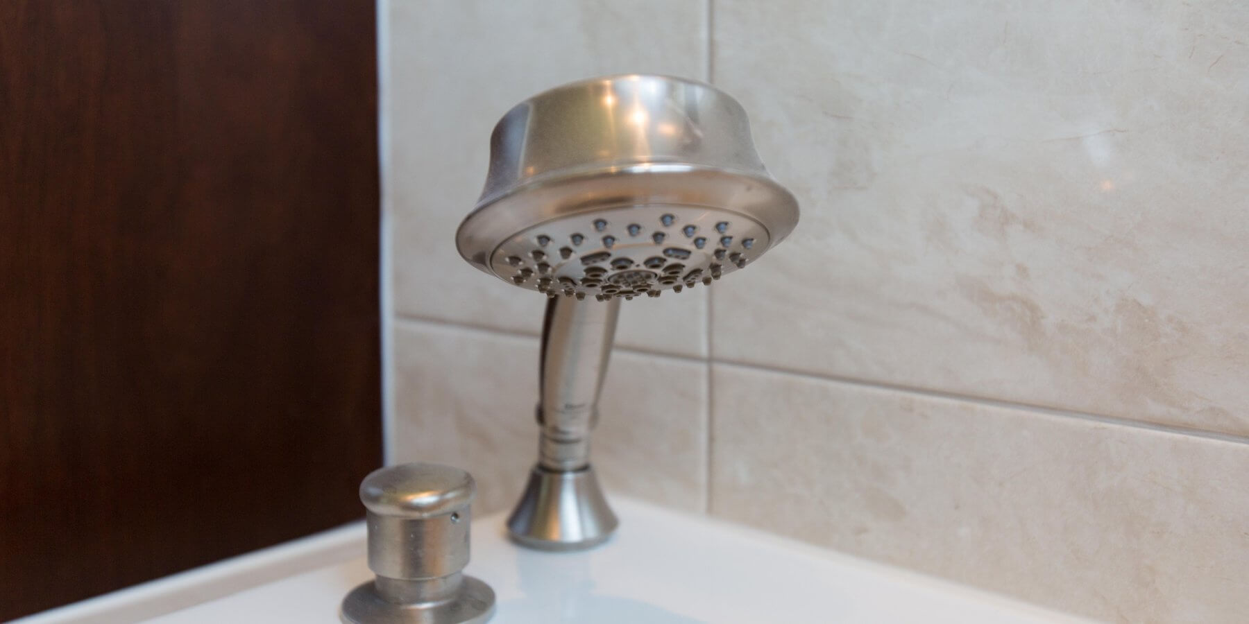 a close up of a shower head on a sink