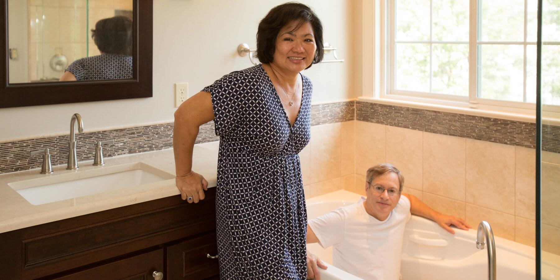 a woman and man standing in a bathtub
