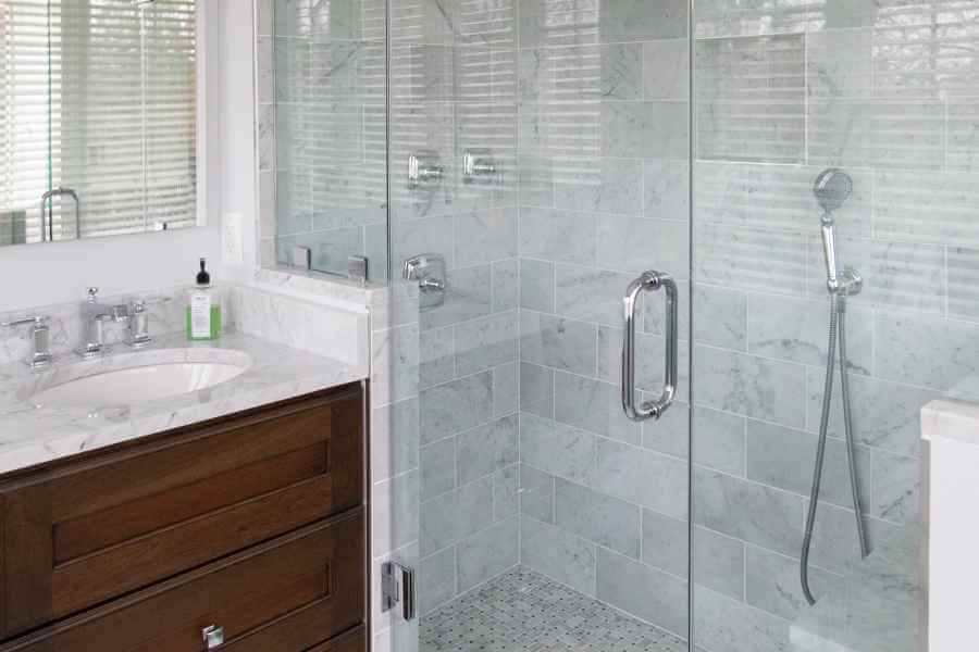 a bathroom with a walk in shower next to a sink