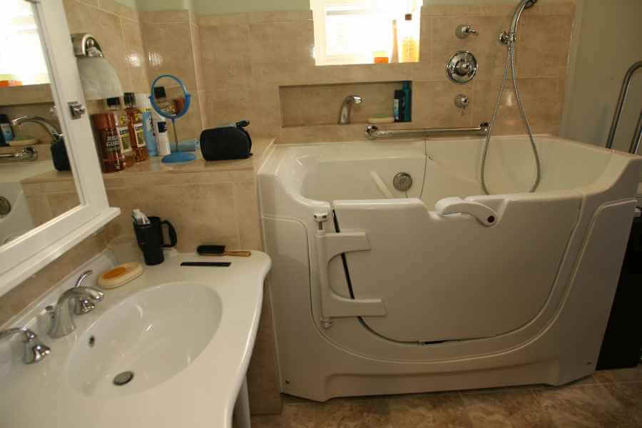 a bathroom with a sink, mirror and bathtub