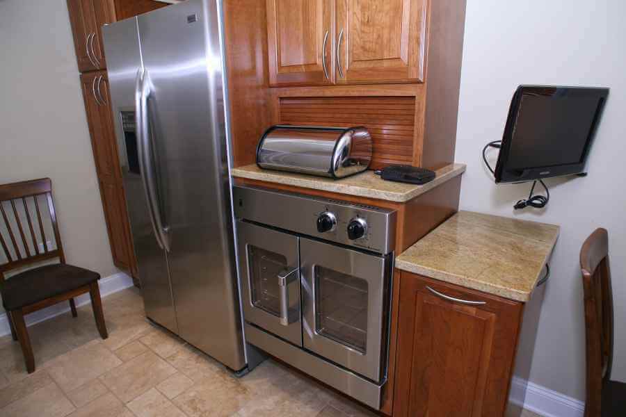 a stainless steel refrigerator and oven in a kitchen