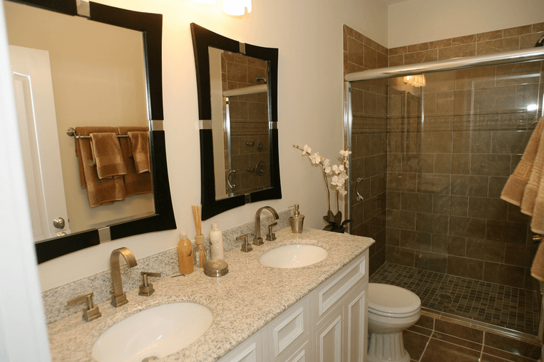 a bathroom with two sinks and a shower