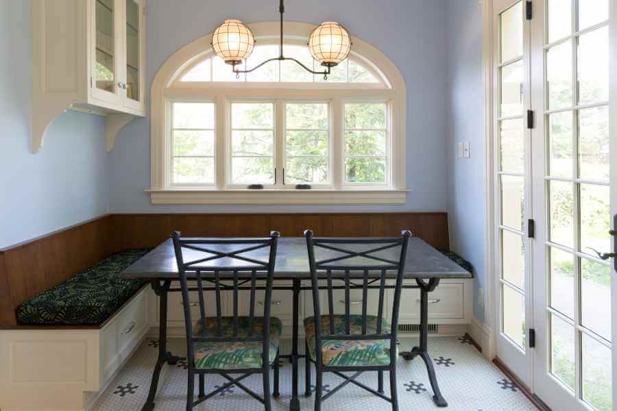 a dining room table with four chairs and a bench