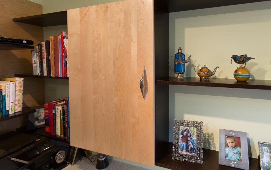 a book shelf with books and pictures on it