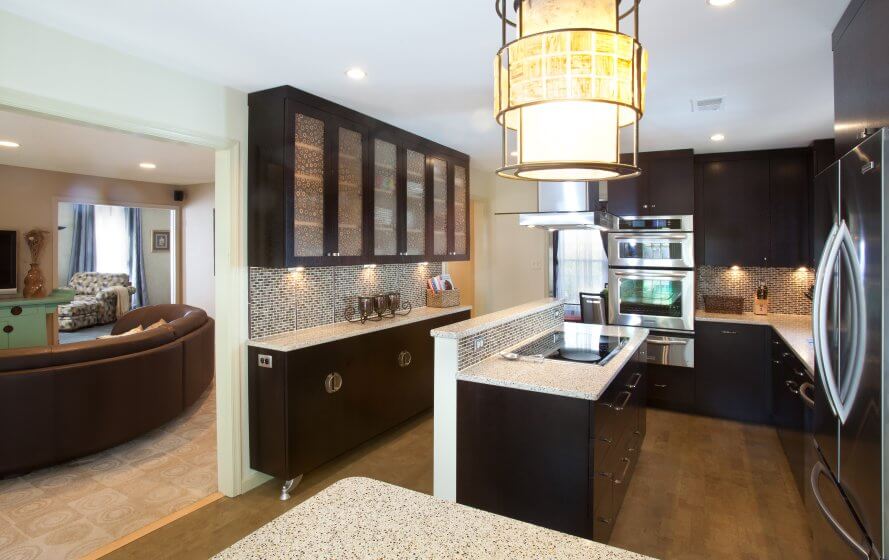 a modern kitchen with black cabinets and white counter tops