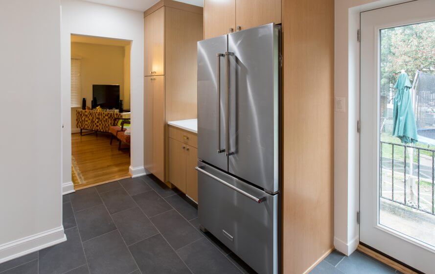 a stainless steel refrigerator freezer sitting inside of a kitchen