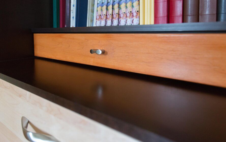 a close up of a drawer with books in the background