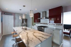 Kitchen remodel with stone countertops, pendant lighting over island, and stainless steel appliances.