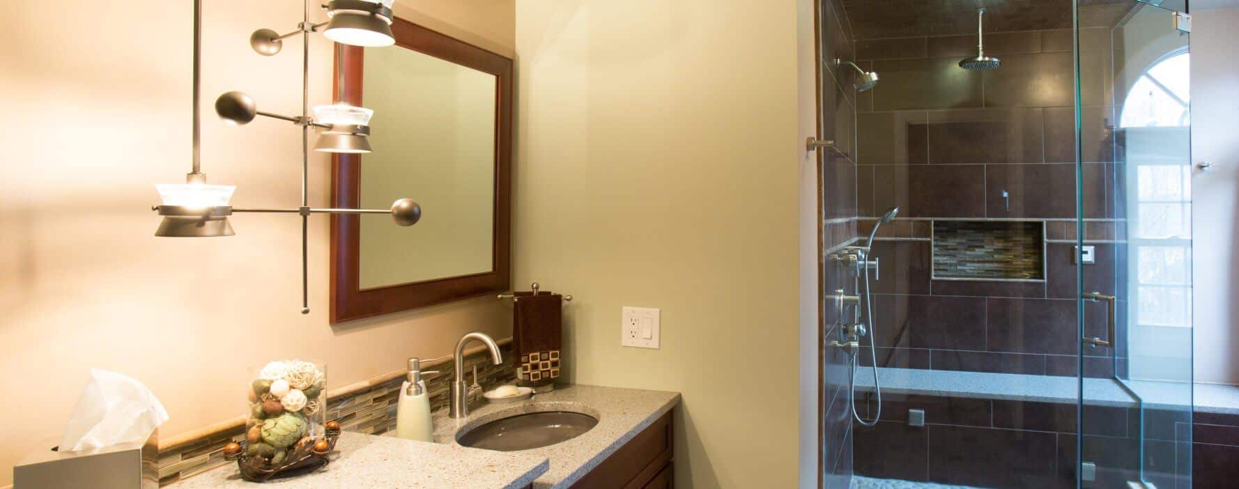 a bathroom with a walk in shower next to a sink