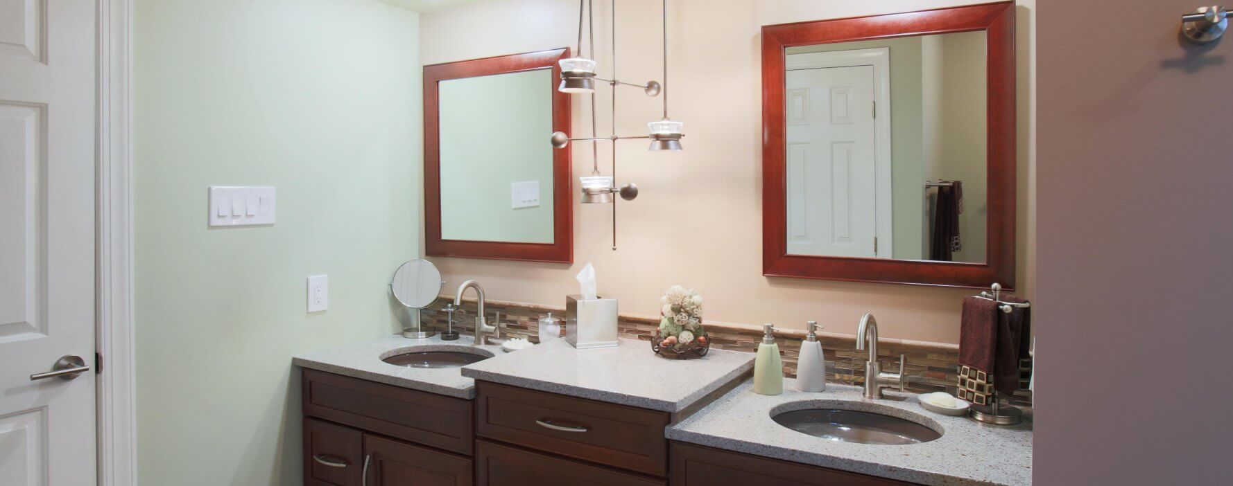 a bathroom with two sinks and mirrors in it