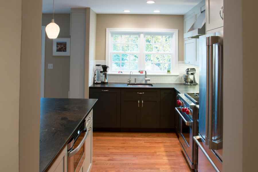 a kitchen with a refrigerator, stove and sink