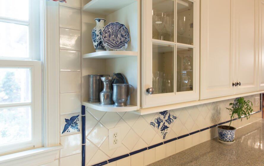 a kitchen counter with blue and white dishes on it