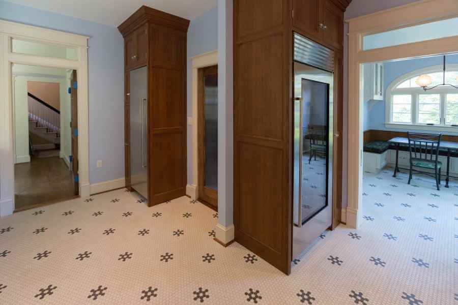 an empty room with wooden doors and tile flooring